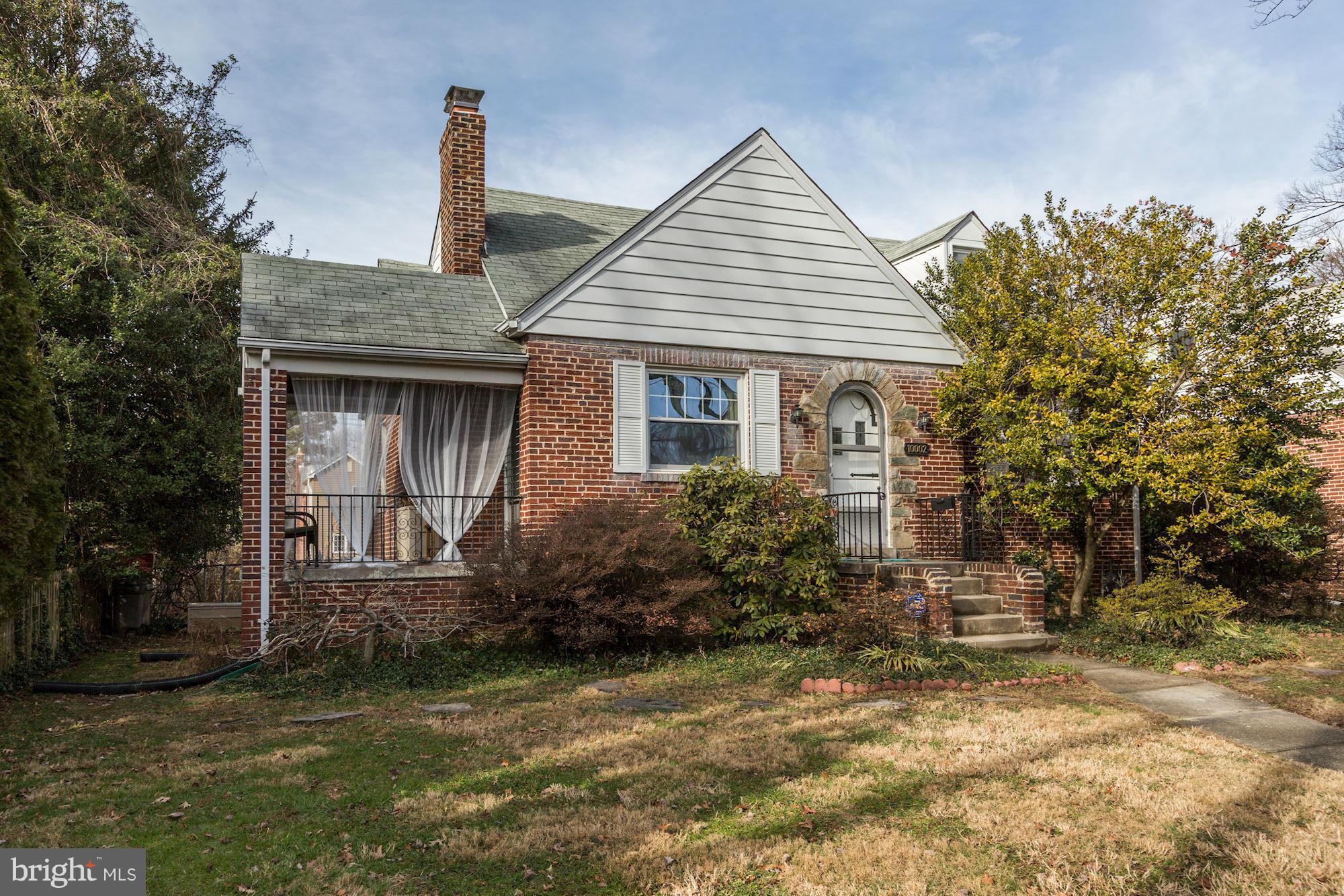 10002 Rogart Road Silver Spring, MD 20901 - Photo 2 of 28 a front view of a house with garden