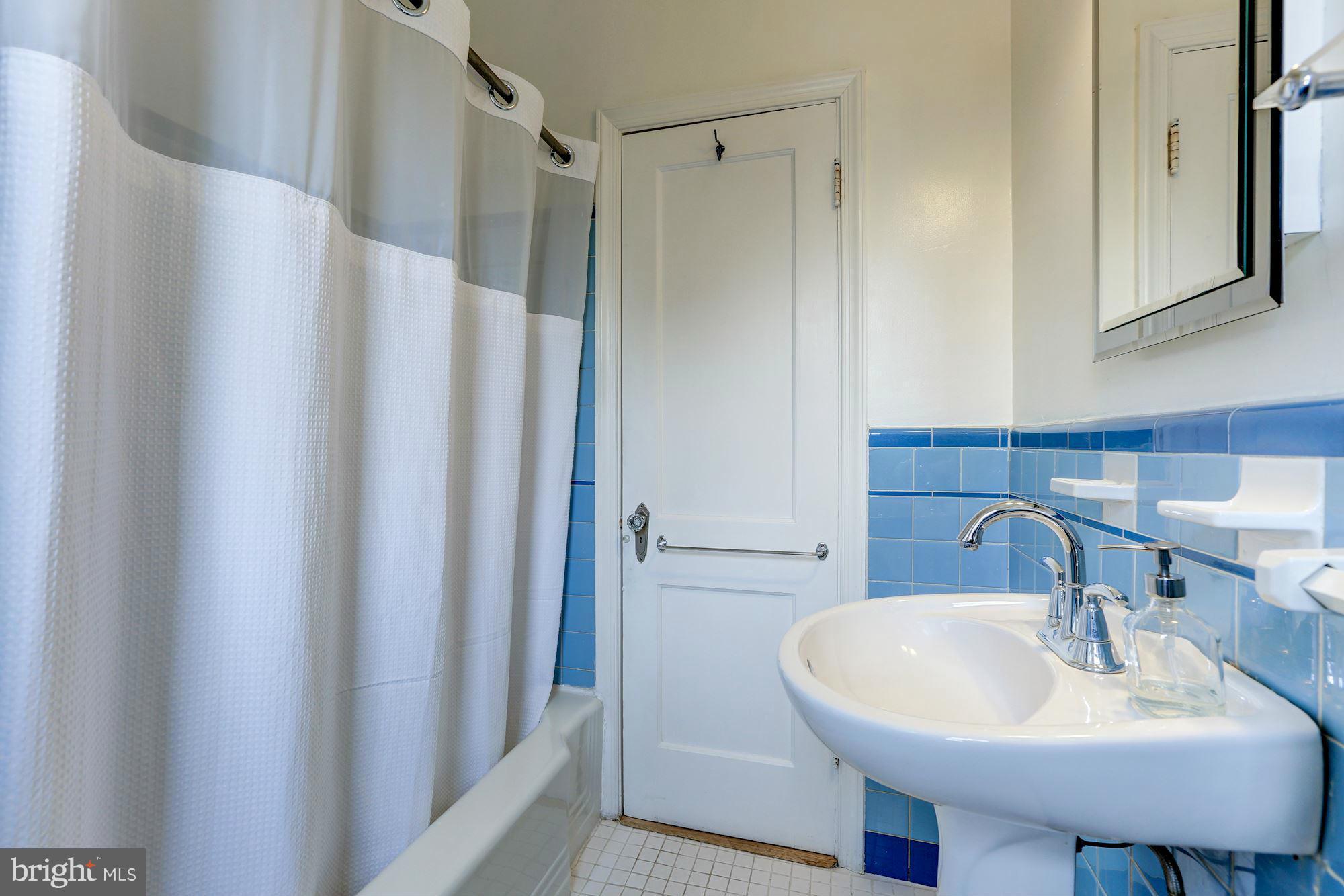 10002 Rogart Road Silver Spring, MD 20901 - Photo 11 of 28 a bathroom with a sink and a mirror