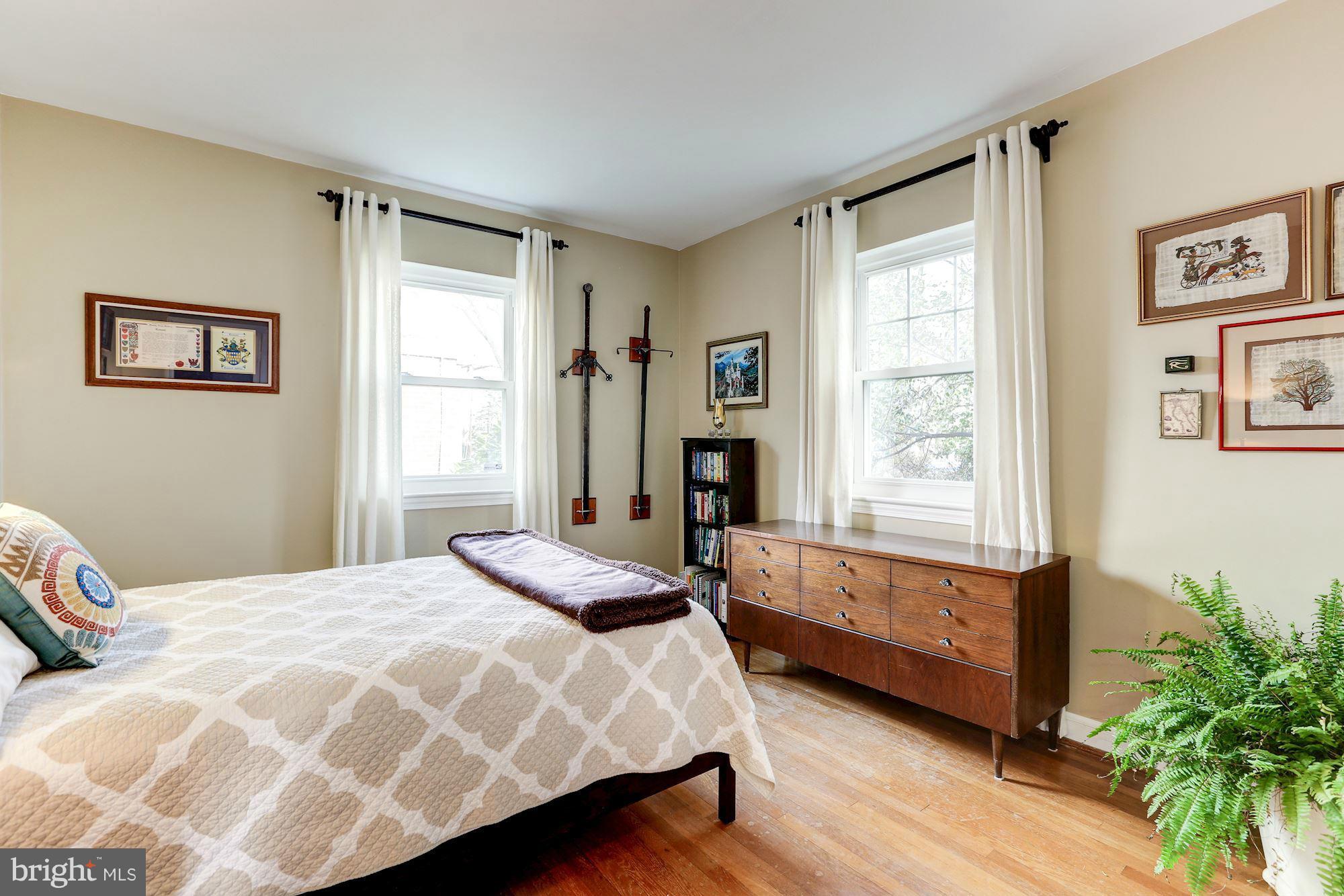 10002 Rogart Road Silver Spring, MD 20901 - Photo 13 of 28 a bedroom with a bed and a window