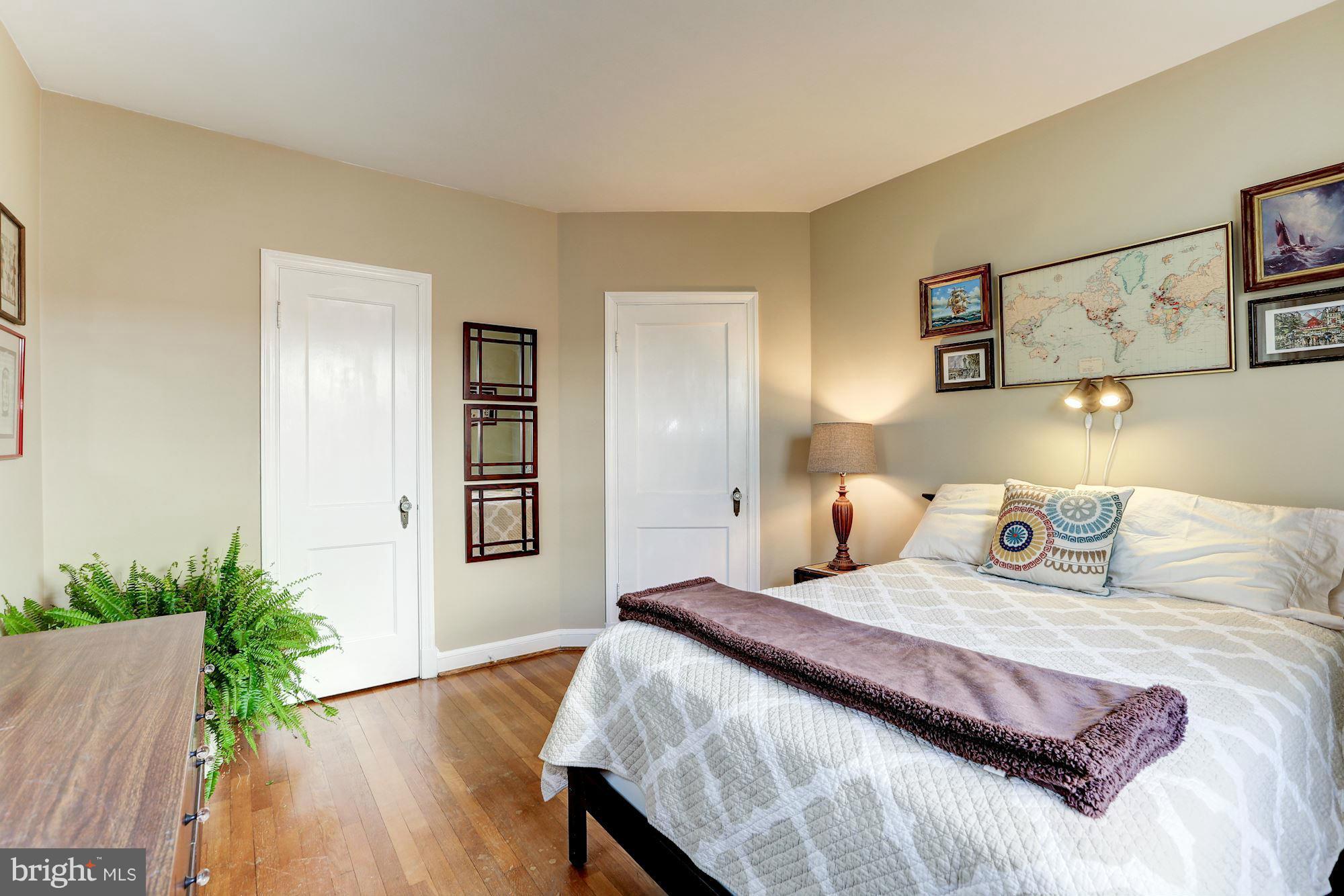 10002 Rogart Road Silver Spring, MD 20901 - Photo 14 of 28 a bedroom with a bed and a potted plant
