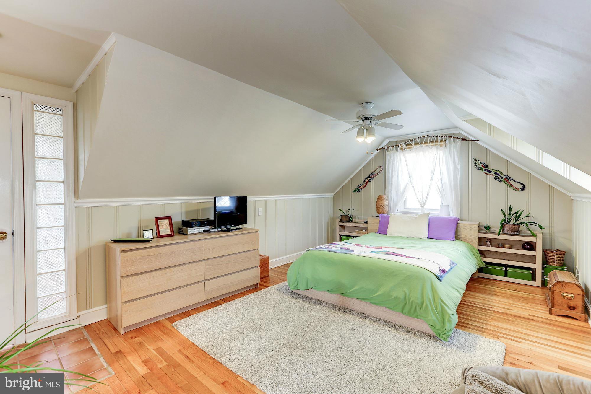 10002 Rogart Road Silver Spring, MD 20901 - Photo 16 of 28 a bedroom with a bed and a dresser