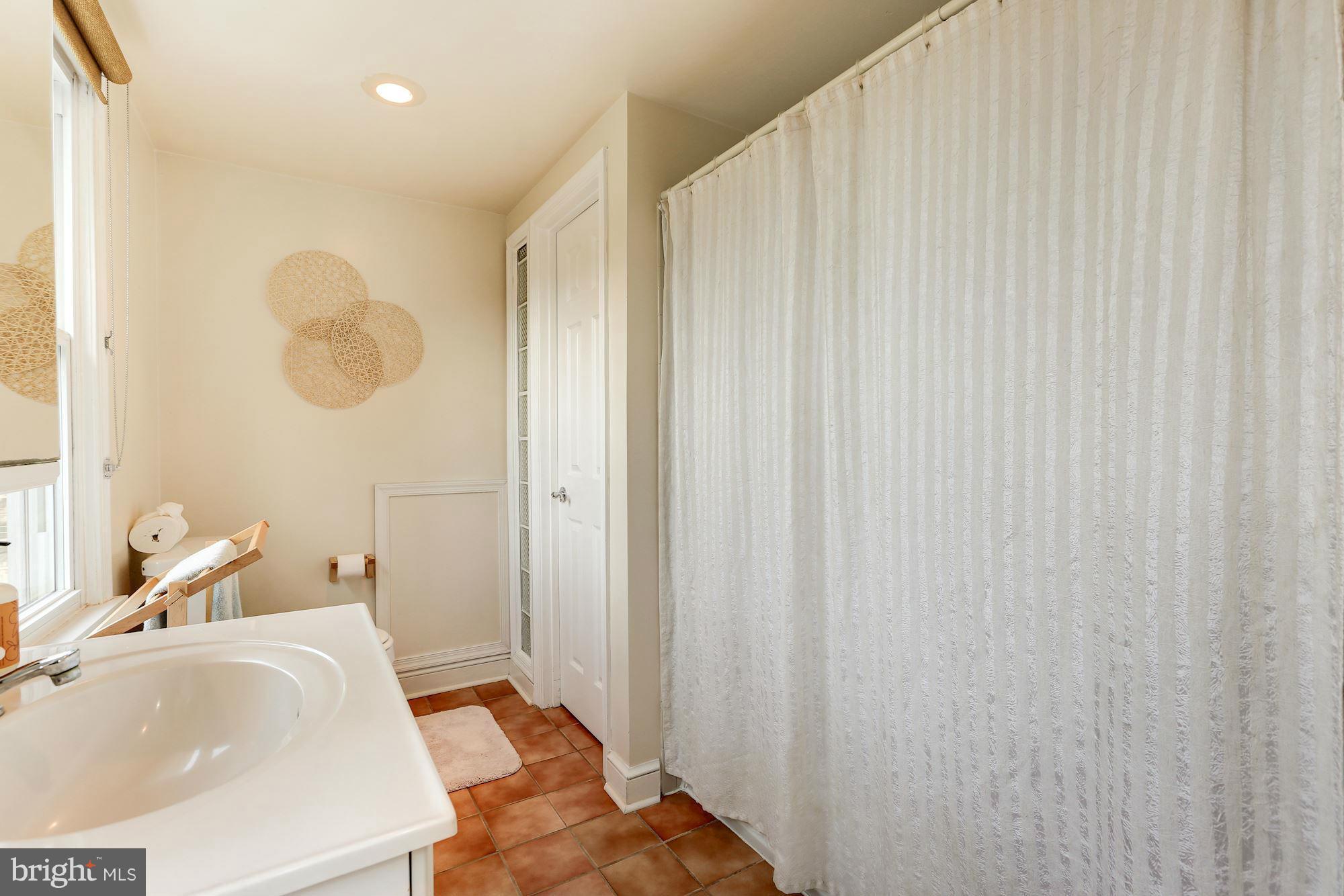 10002 Rogart Road Silver Spring, MD 20901 - Photo 19 of 28 a bathroom with a sink and a mirror
