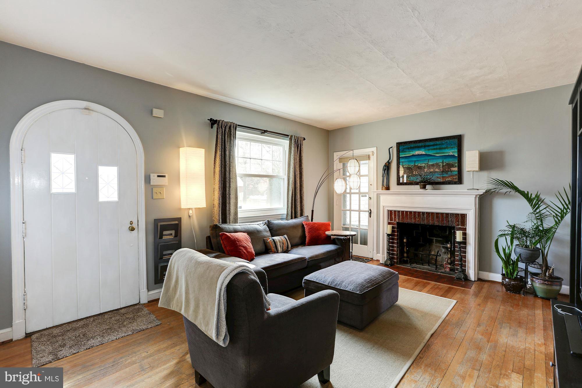 10002 Rogart Road Silver Spring, MD 20901 - Photo 3 of 28 a living room with furniture and a fireplace