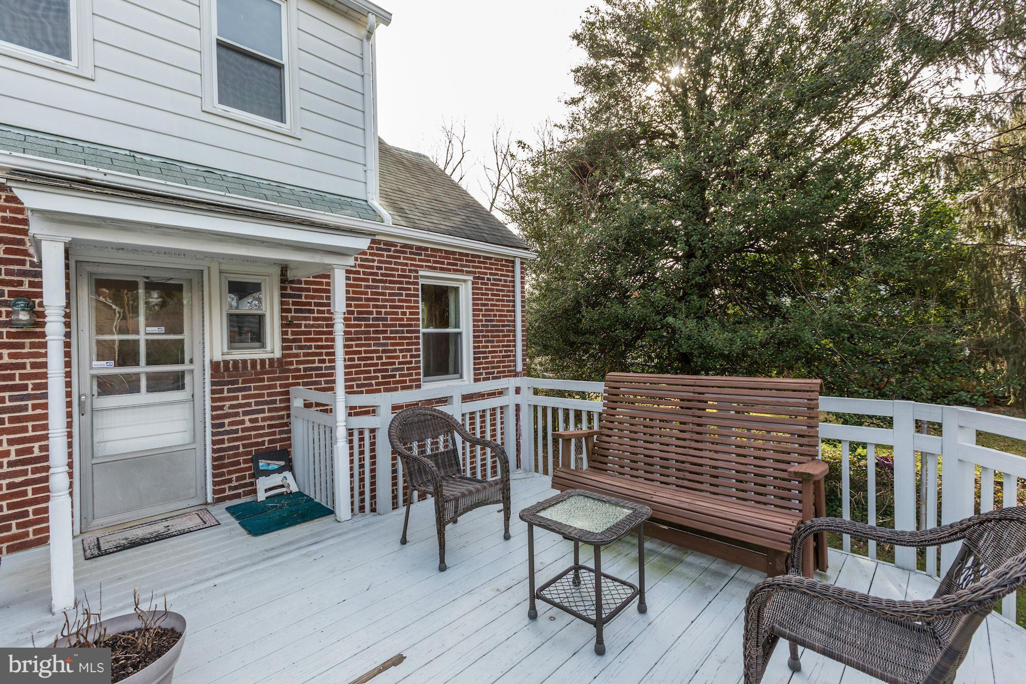 10002 Rogart Road Silver Spring, MD 20901 - Photo 23 of 28 a view of a chair and table on the deck