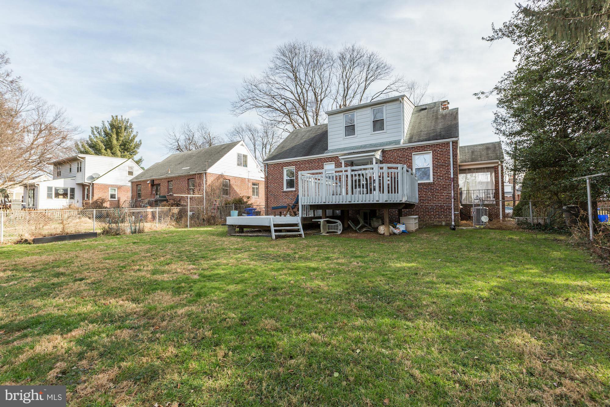 10002 Rogart Road Silver Spring, MD 20901 - Photo 28 of 28 a front view of a house with a garden and deck