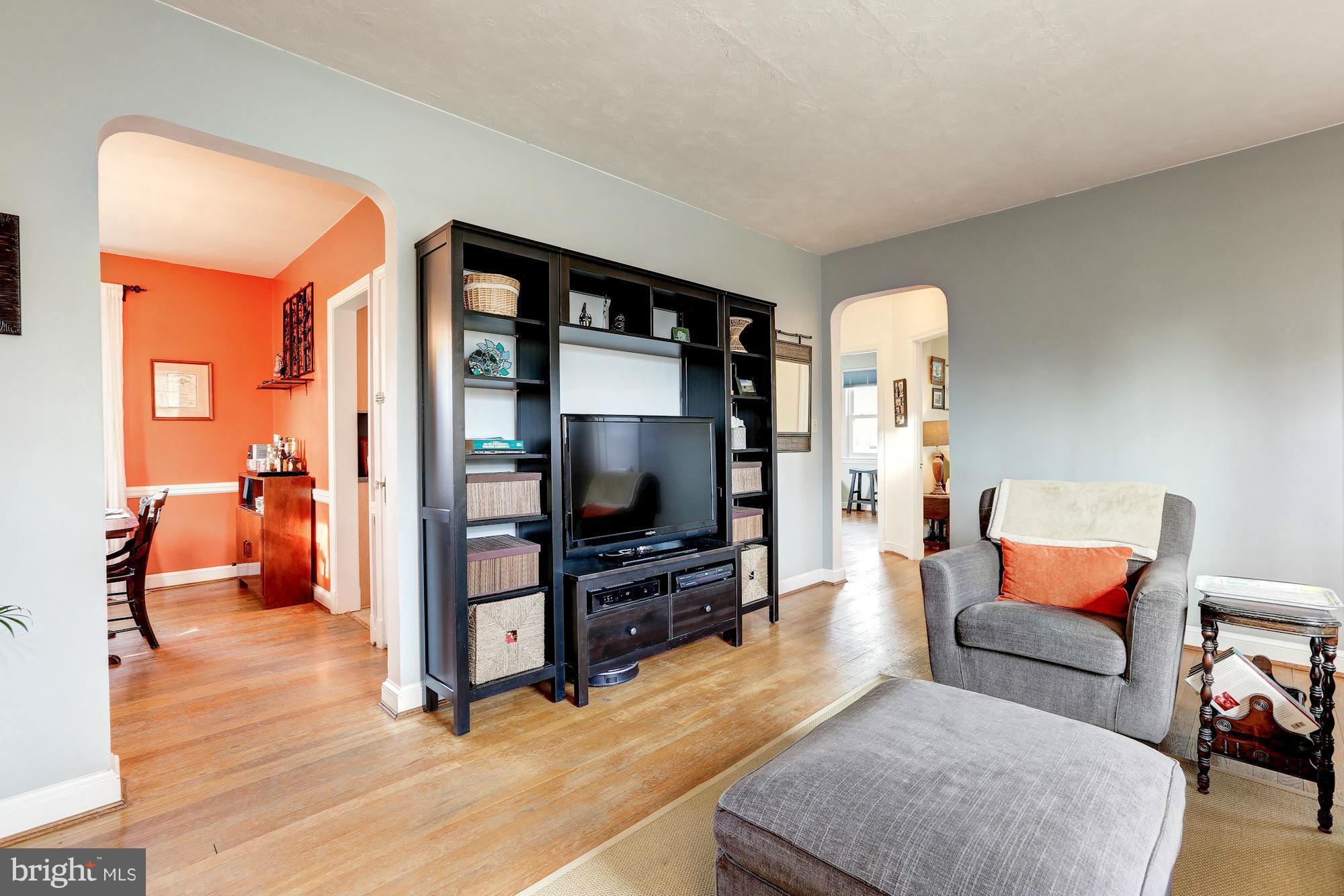 10002 Rogart Road Silver Spring, MD 20901 - Photo 5 of 28 a living room with furniture and a flat screen tv