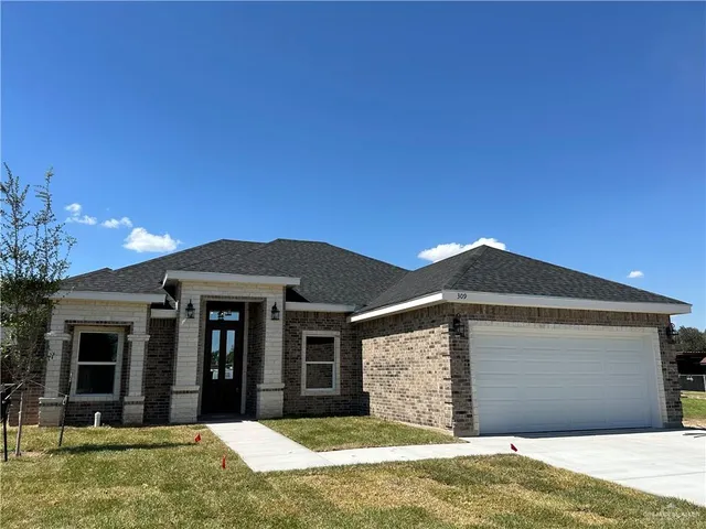 a front view of a house with a yard