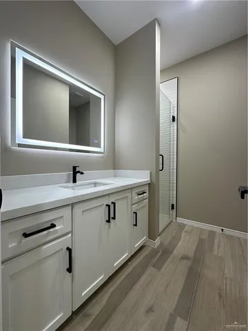 a view of room with hardwood floor and ceiling fan