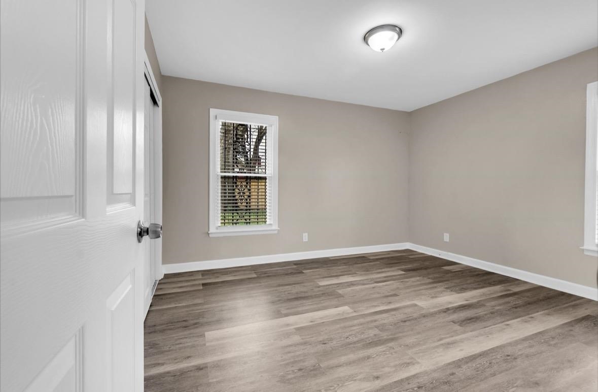 1649 Babs Road Memphis, TN 38116 - Photo 11 of 20 wooden floor in an empty room with a window