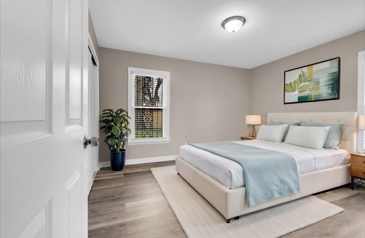 1649 Babs Road Memphis, TN 38116 - Photo 12 of 20 a bedroom with a large bed and a potted plant