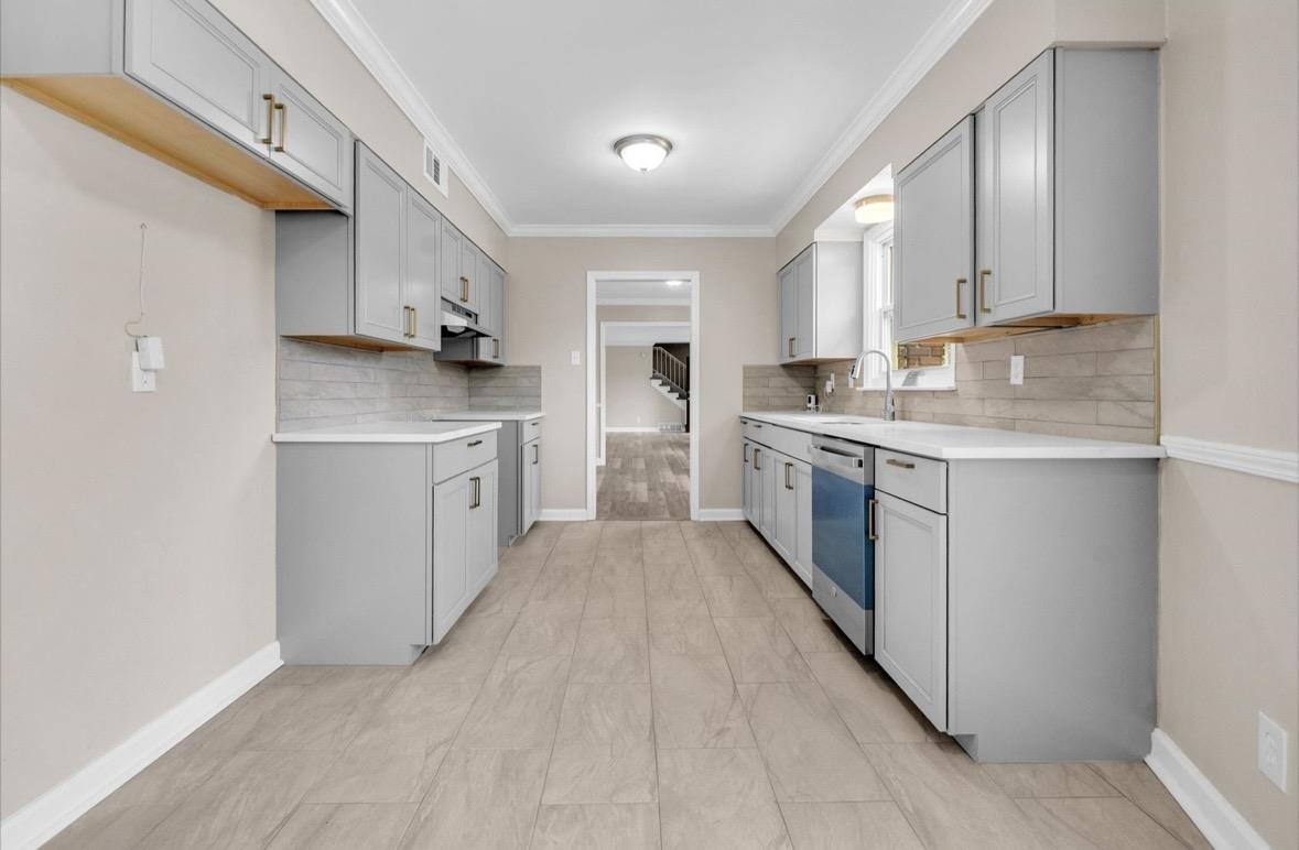1649 Babs Road Memphis, TN 38116 - Photo 3 of 20 a kitchen with stainless steel appliances granite countertop a stove a sink and a refrigerator