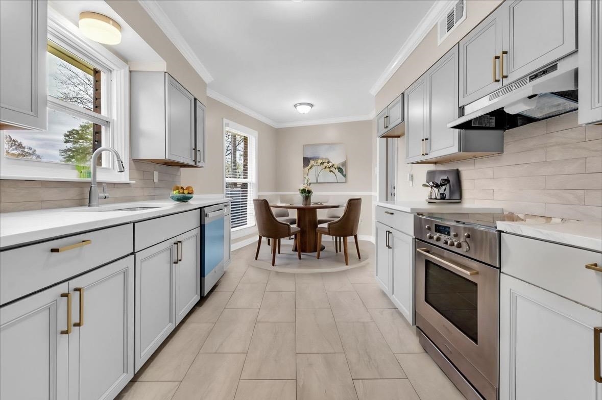 1649 Babs Road Memphis, TN 38116 - Photo 5 of 20 a kitchen with a stove sink cabinets and appliances
