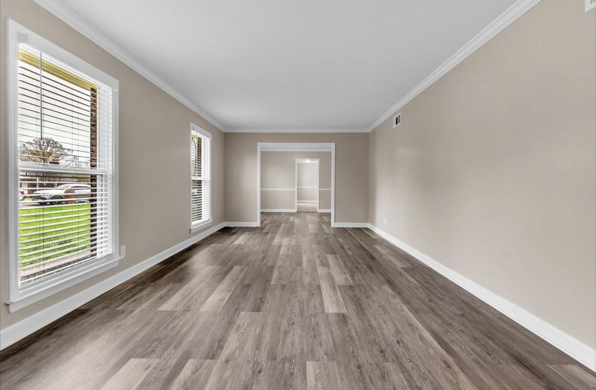 1649 Babs Road Memphis, TN 38116 - Photo 6 of 20 wooden floor in an empty room with a window