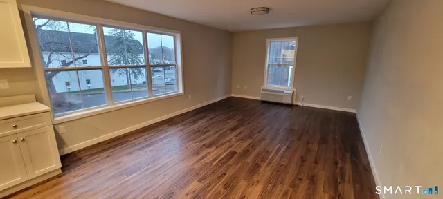 a view of a room with wooden floor and doors