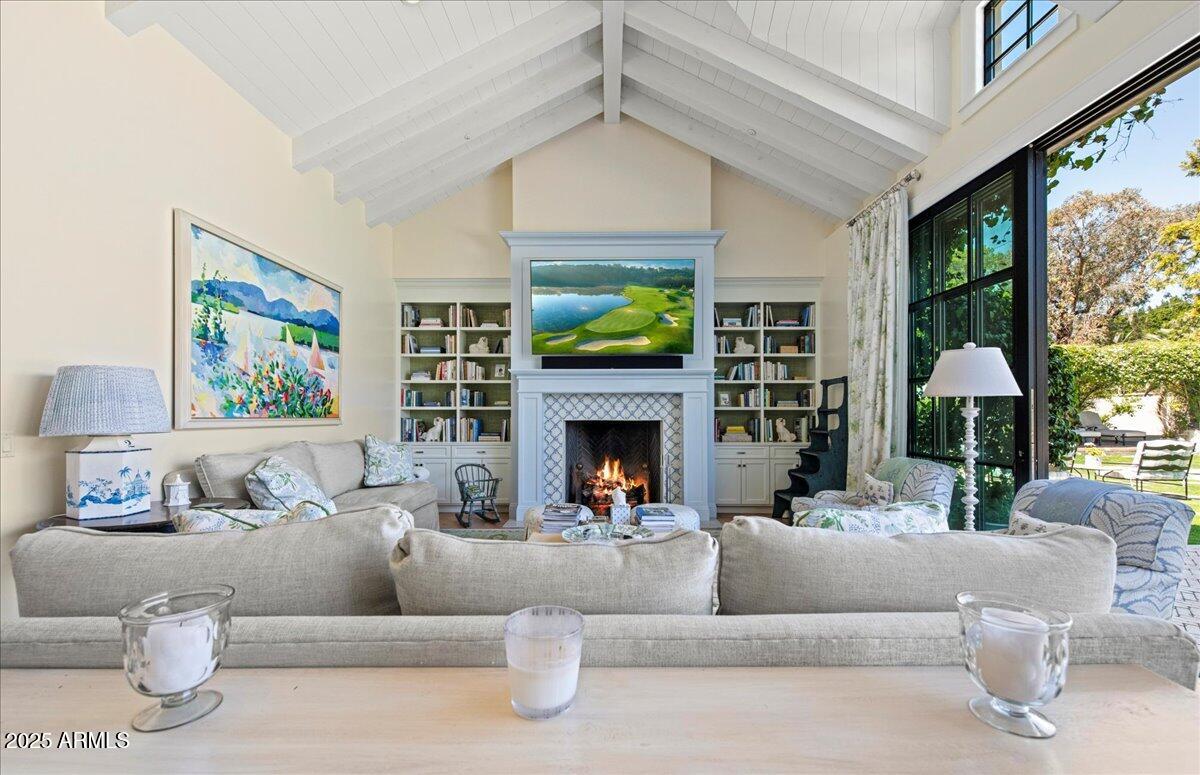 5446 East Exeter Boulevard Phoenix, AZ 85018 - Photo 12 of 59 a living room with furniture a fireplace and a large window