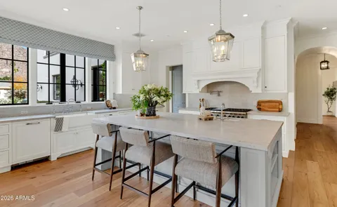 a living room with furniture a fireplace and a chandelier