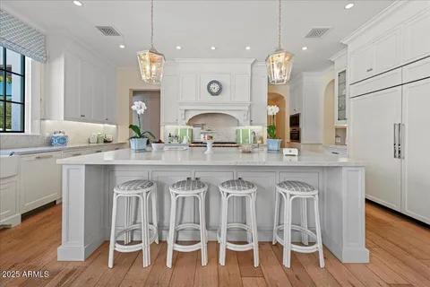 a kitchen with stainless steel appliances granite countertop a lot of counter space and wooden floors