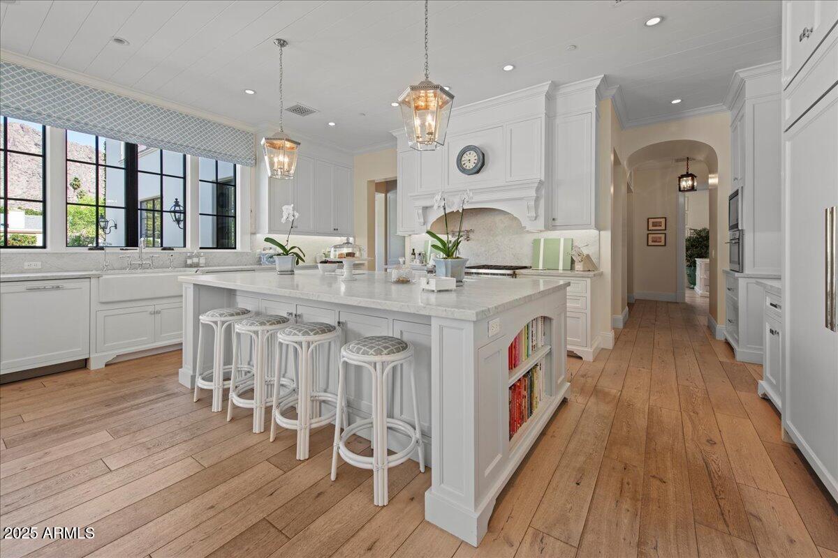 5446 East Exeter Boulevard Phoenix, AZ 85018 - Photo 19 of 59 a kitchen with stainless steel appliances granite countertop a lot of counter space and wooden floors