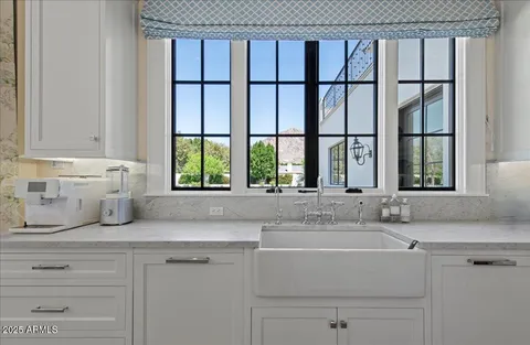 a kitchen with stainless steel appliances granite countertop a sink a stove and a refrigerator