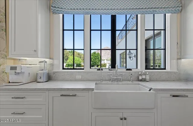 a kitchen with stainless steel appliances granite countertop a sink a stove and a refrigerator