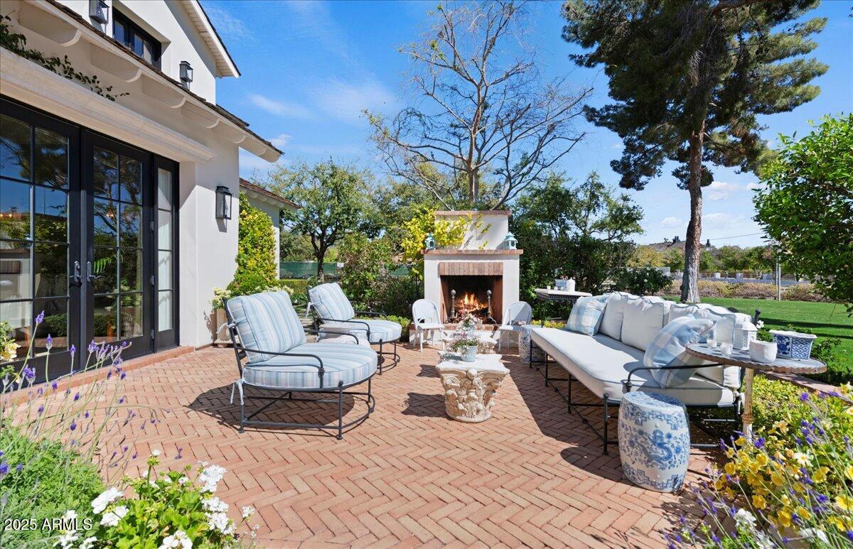 5446 East Exeter Boulevard Phoenix, AZ 85018 - Photo 2 of 59 a view of a patio with couches table and chairs and potted plants