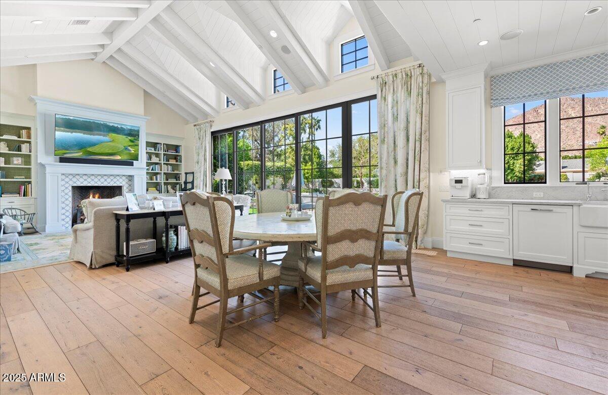 5446 East Exeter Boulevard Phoenix, AZ 85018 - Photo 22 of 59 a view of a dining room with furniture window and wooden floor