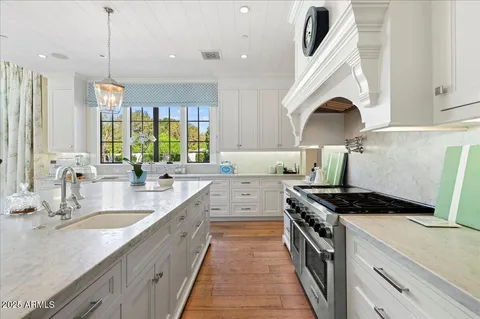 a hallway with mirror and cabinets