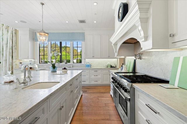 a hallway with mirror and cabinets