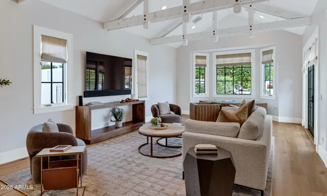 a view of house with a big yard and large trees