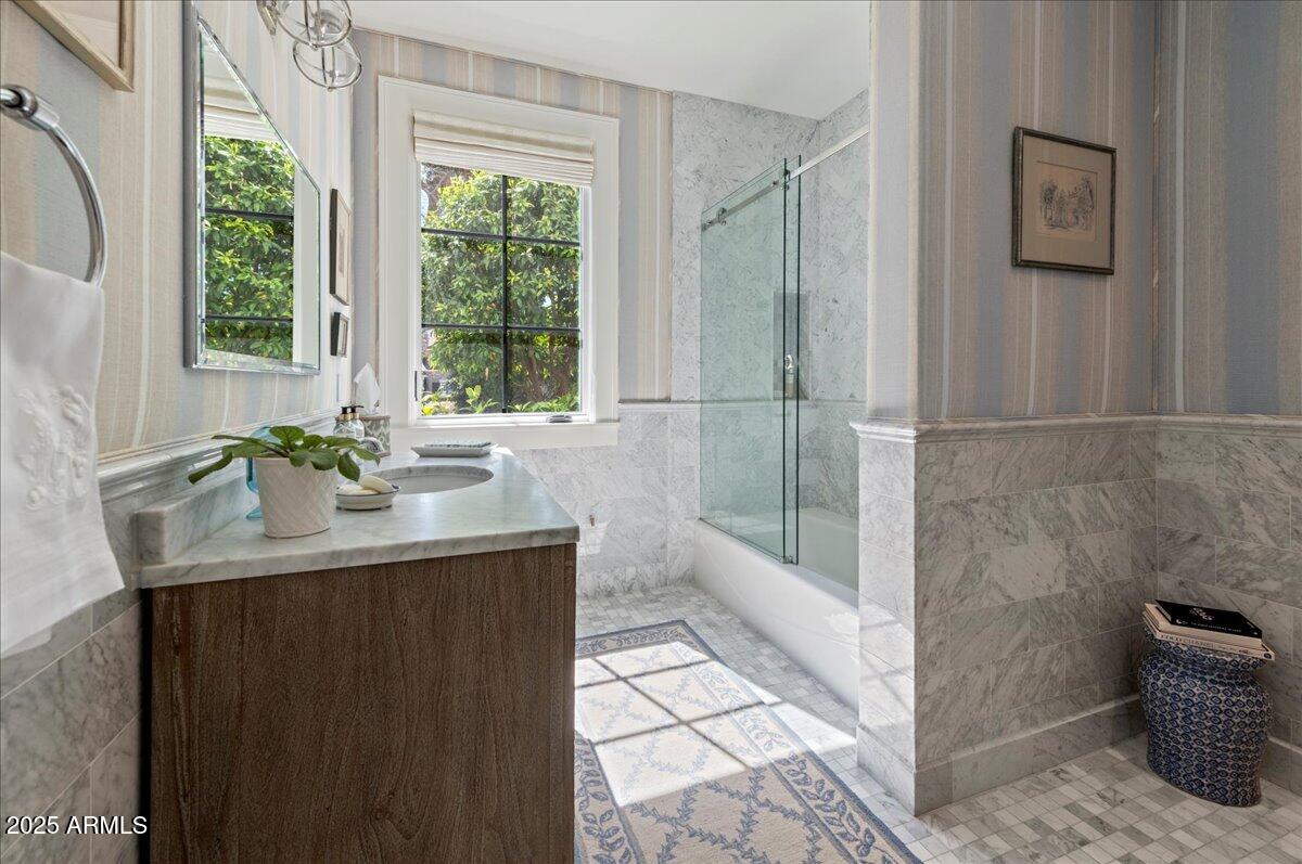 5446 East Exeter Boulevard Phoenix, AZ 85018 - Photo 36 of 59 a bathroom with a granite countertop sink a toilet a mirror and next to a window