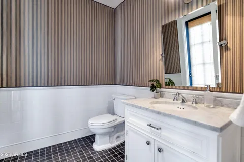 a view of a tennis ground with large trees