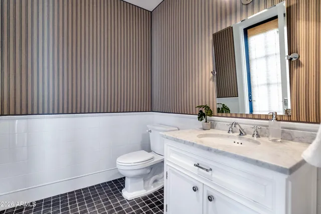 a view of a tennis ground with large trees