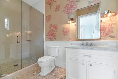 a front view of a house with a garden and yard