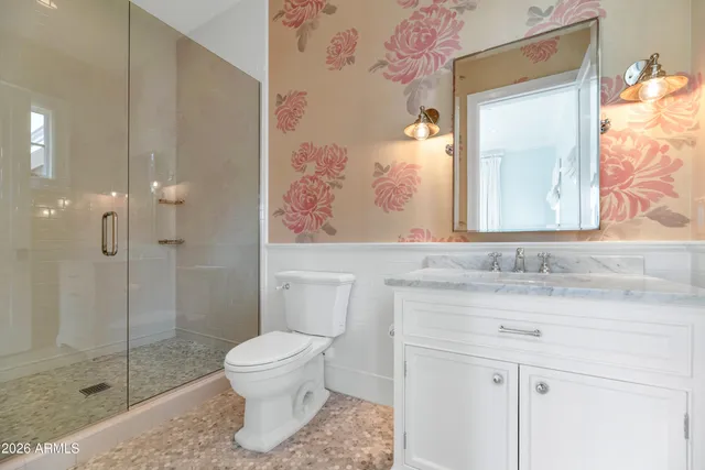 a front view of a house with a garden and yard