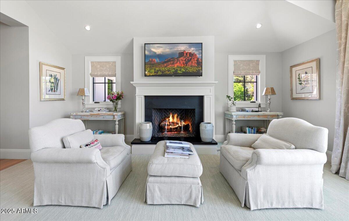 5446 East Exeter Boulevard Phoenix, AZ 85018 - Photo 47 of 59 a living room with furniture a fireplace and a flat screen tv