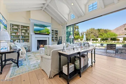 a living room with furniture a fireplace and a table