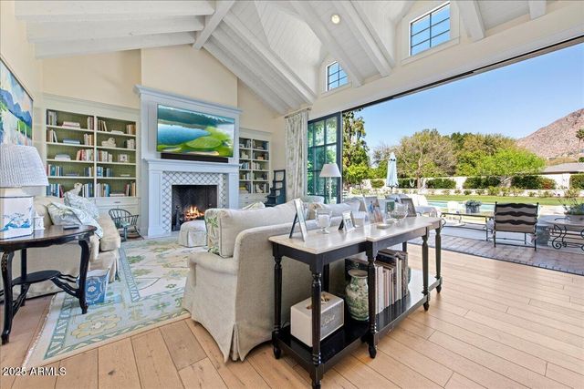 a living room with furniture a fireplace and a table