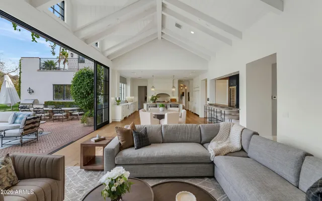 a living room with fireplace furniture and a large window