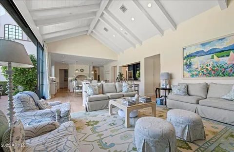a living room with furniture fireplace and a large window
