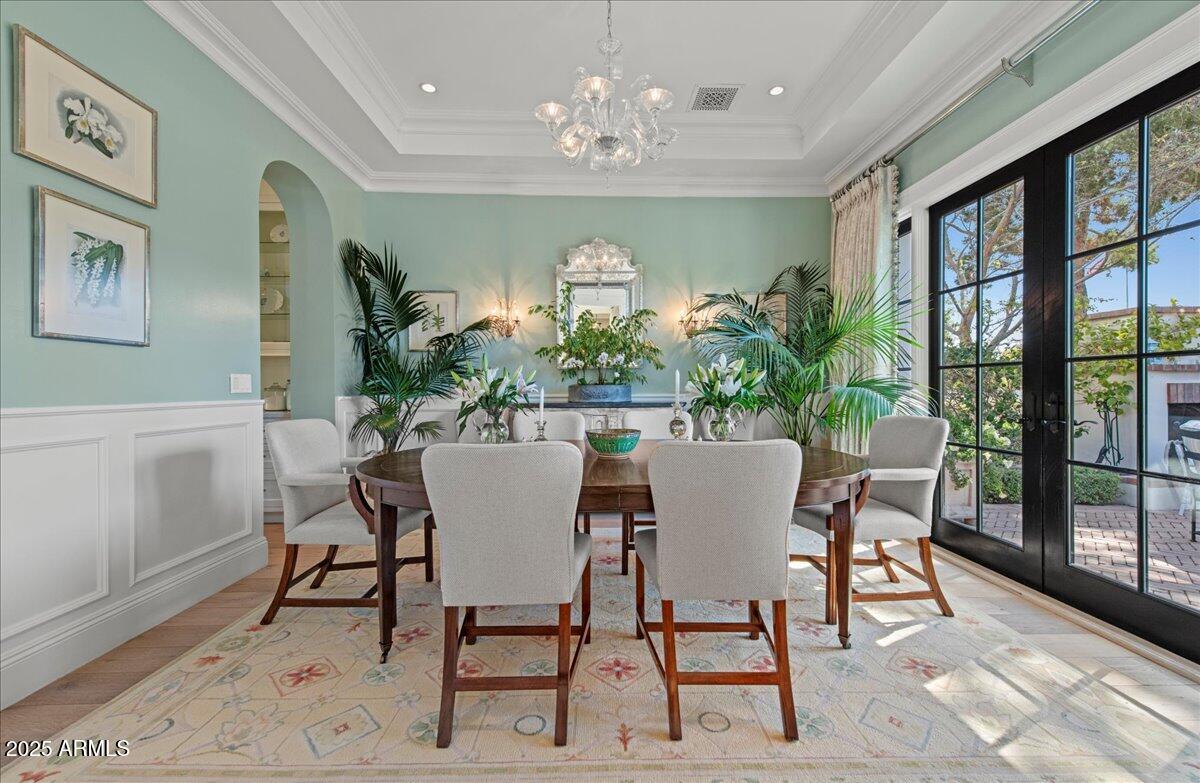 5446 East Exeter Boulevard Phoenix, AZ 85018 - Photo 10 of 59 a view of a dining room with furniture a chandelier and wooden floor