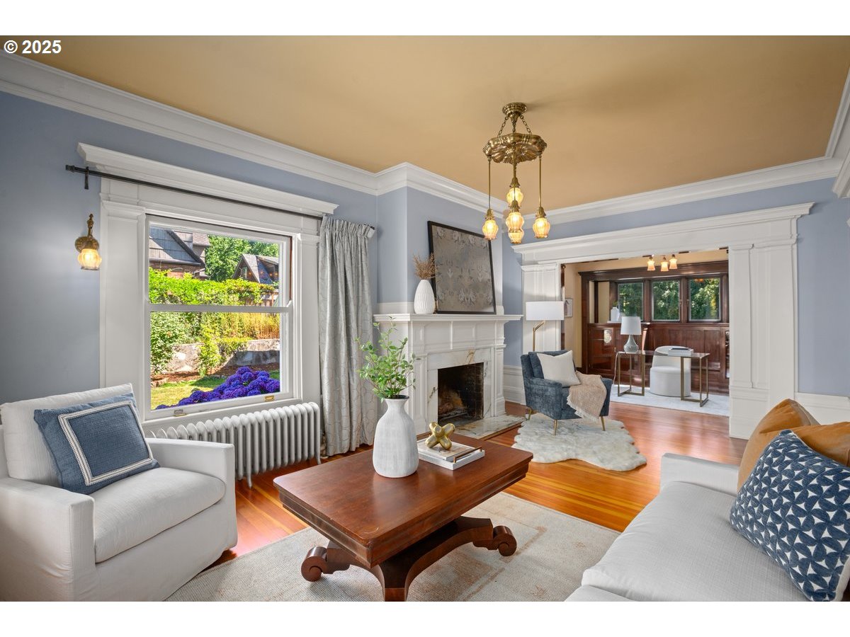 1314 Southeast 55th Avenue Portland, OR 97215 - Photo 11 of 47 a living room with furniture a chandelier and a fireplace