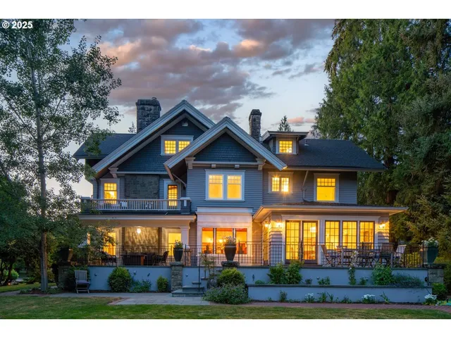 a front view of house with yard and trees in the background
