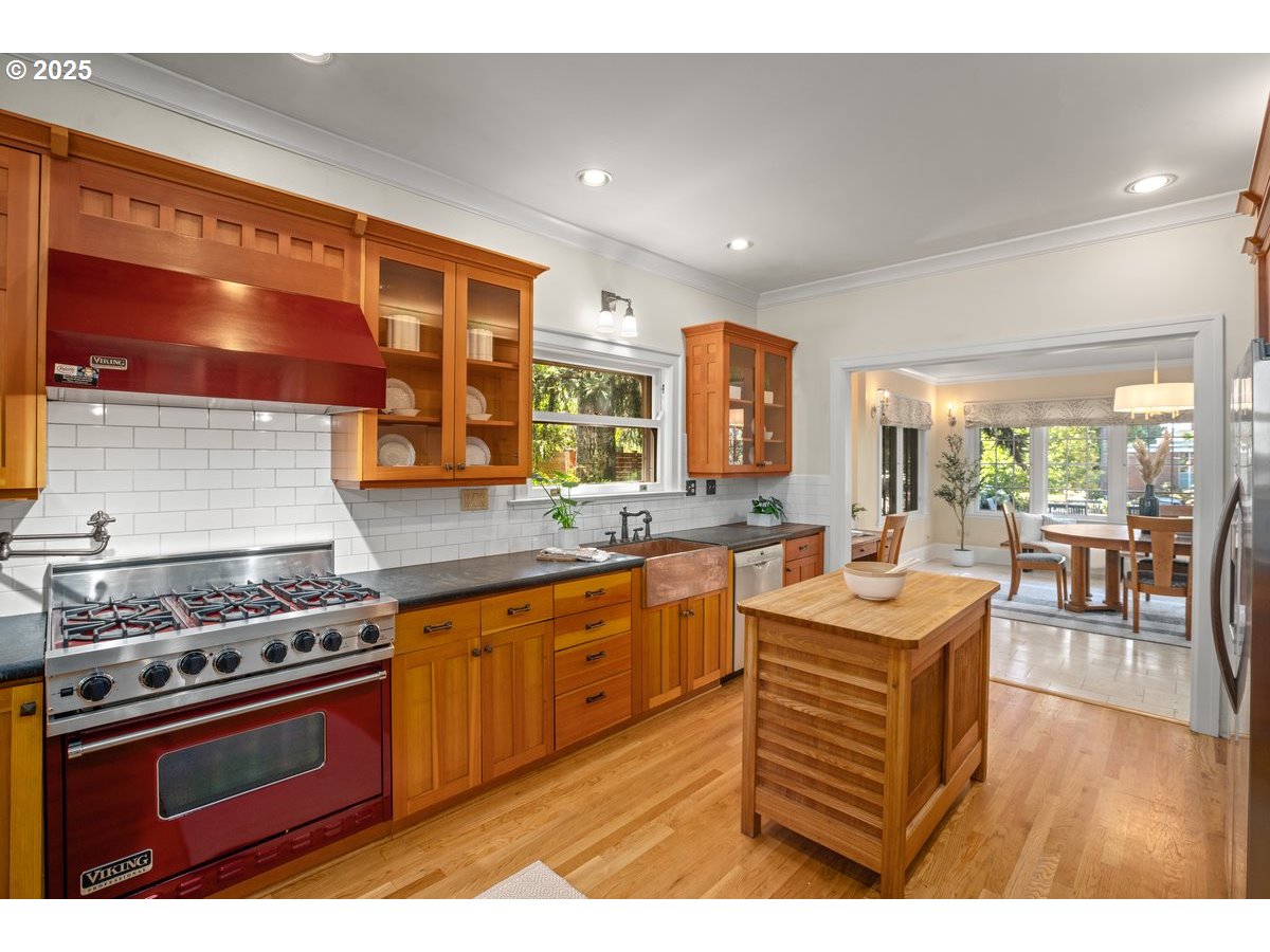 1314 Southeast 55th Avenue Portland, OR 97215 - Photo 22 of 47 a kitchen with stainless steel appliances a stove a sink dishwasher and cabinets with wooden floor