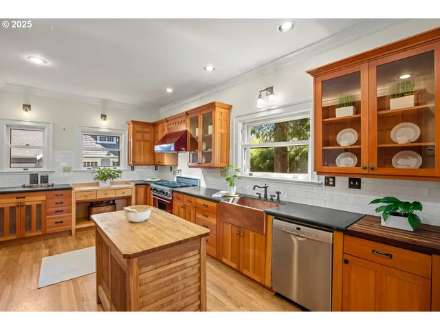 a living room with stainless steel appliances kitchen island granite countertop furniture and a large window