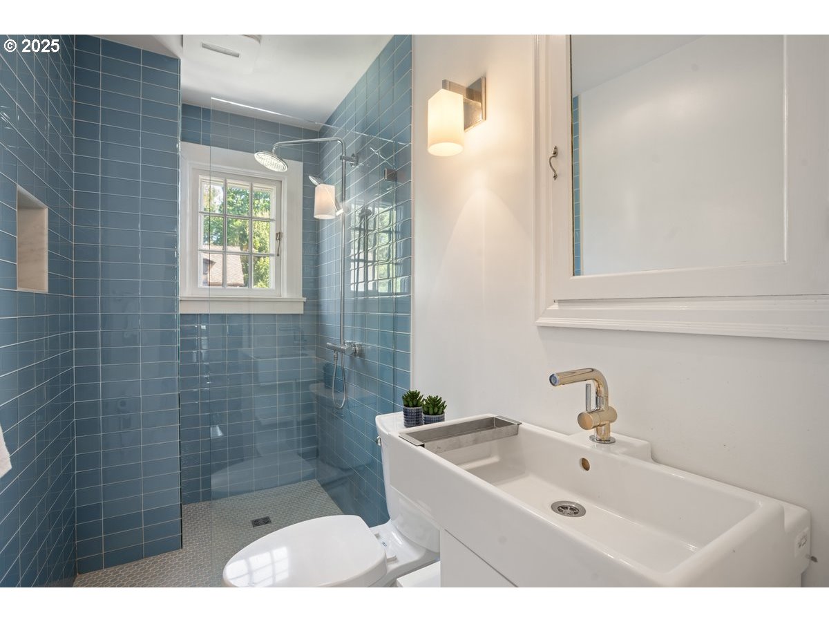1314 Southeast 55th Avenue Portland, OR 97215 - Photo 29 of 47 a bathroom with a sink a mirror and a shower