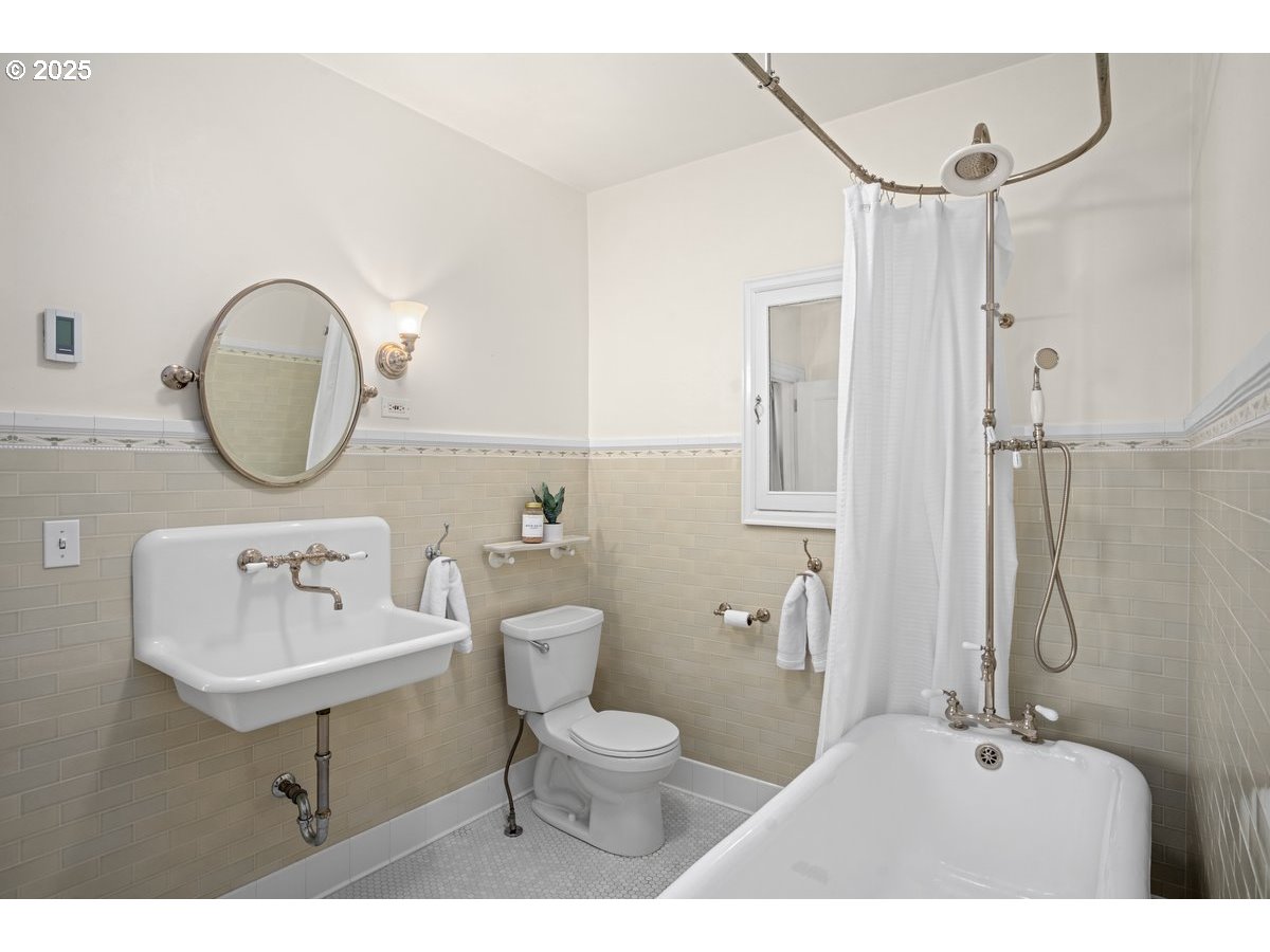 1314 Southeast 55th Avenue Portland, OR 97215 - Photo 36 of 47 a bathroom with a toilet a sink and mirror