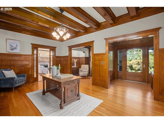 a living room with furniture a fireplace and a floor to ceiling window