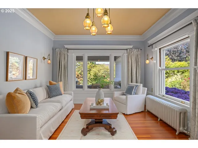 a living room with furniture a chandelier and a fireplace