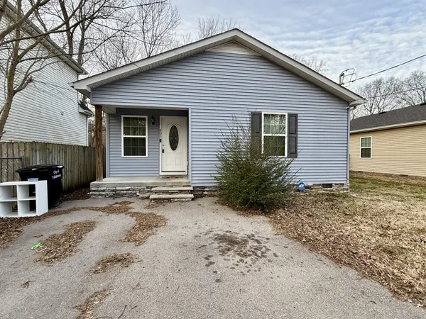 a view of a house with a yard and garage