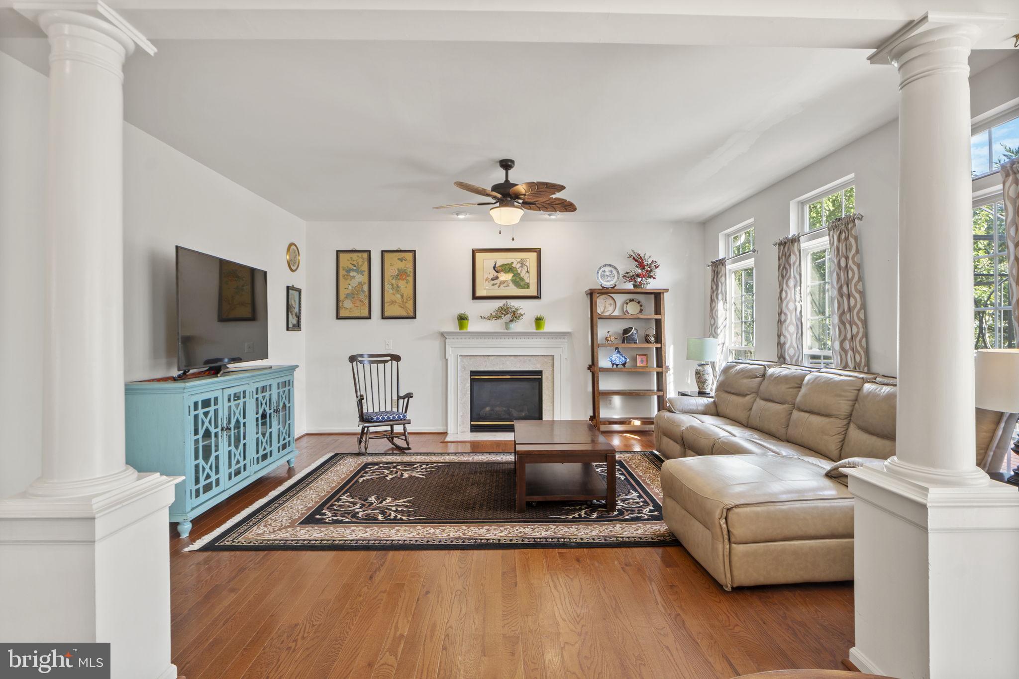 6528 Atkins Way Gainesville, VA 20155 - Photo 14 of 50 a living room with furniture a flat screen tv and a fireplace